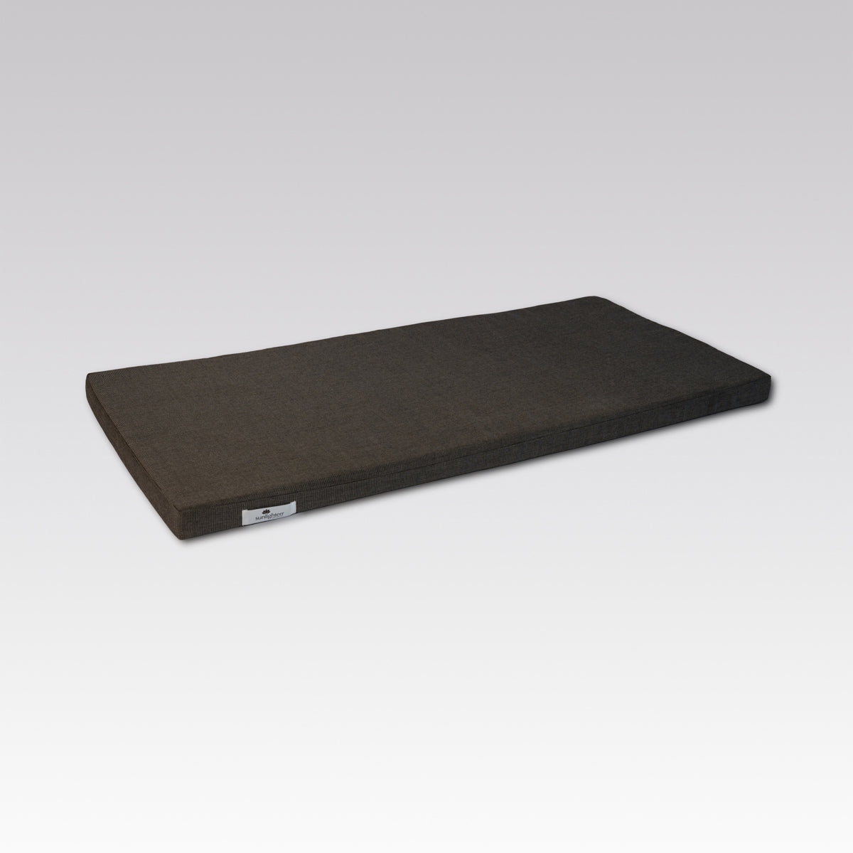 A dark gray rectangular sauna bench cushion  photographed on a light gray gradient background.