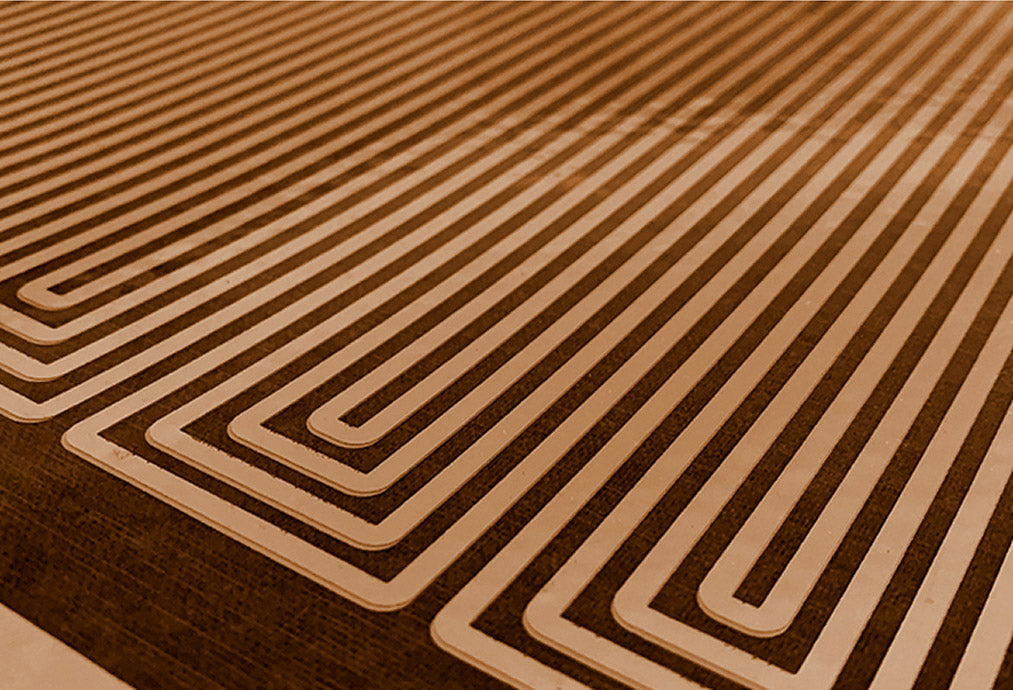 Close-up of a SoloCarbon heater panel with a geometric, maze-like pattern